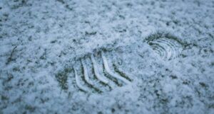 a closeup of a footprint in the snow