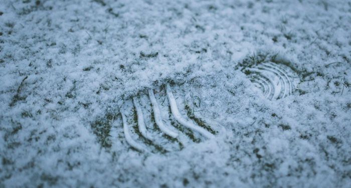 a closeup of a footprint in the snow