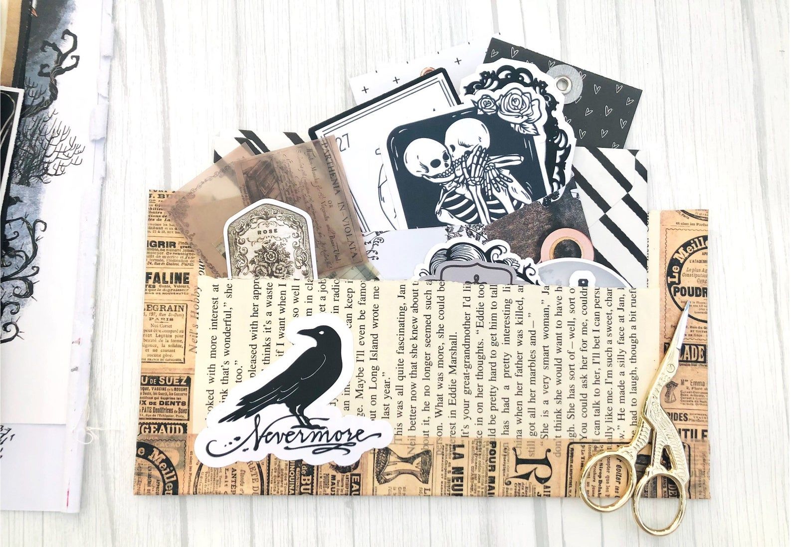 Image of gothic ephemera, including ravens, skulls, and vintage paper. 