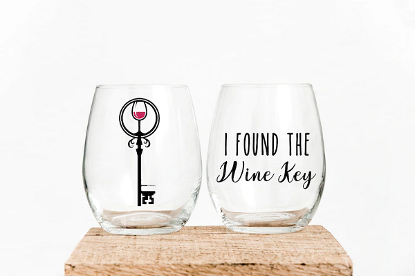 Two stemless wine glasses, side-by-side. One says, "I found the wine key." The other has an ornate key printed on it, with a glass of wine in the bow. 
