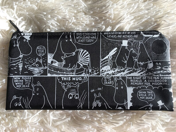A black and white pencil case with panels from the Moomintroll comics.