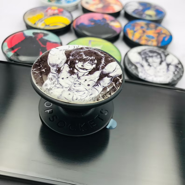 A small arrangement of Pop Sockets, out of focus. In the foreground, in focus, is a Pop Socket with the comic book version of The Crow.