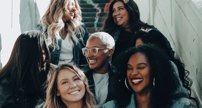 a diverse group of women smiling