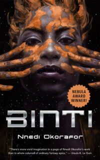 Book cover for Binti, showing a black woman's face with her fingers drawing orange lines cross her cheeks against a black background. The title is in silver beneath the woman's face.