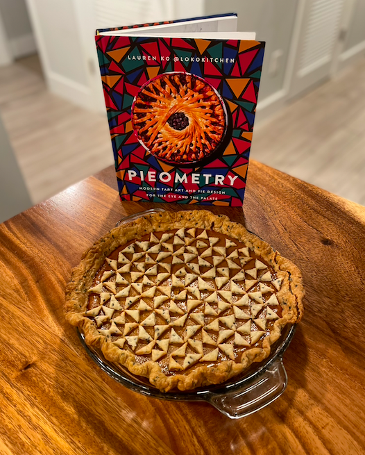 Pumpkin pie topped with a geometric pattern of pastry triangles with Lauren Ko's Pieometry cookbook