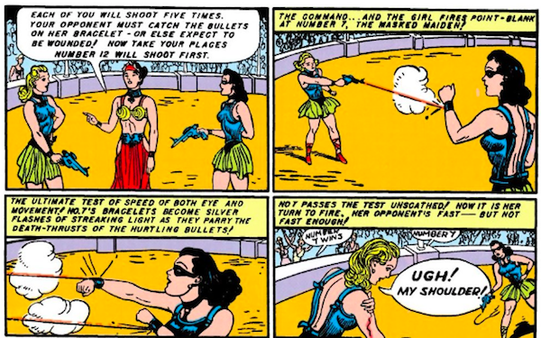 Four panels.

Panel 1: Diana, wearing a mask, and a blonde Amazon face off in an arena, both holding pistols, with Hippolyta presiding.

Hippolyta: Each of you will shoot five times. Your opponent must catch the bullets on her bracelet - or else expect to be wounded! Now take your places. Number 12 will shoot first.

Panel 2: The blonde shoots at Diana, who deflects the bullet with her bracelet.

Narration Box: The command...and the girl fires point-blank at Number 7, the masked maiden!

Panel 3: Diana deflects two more bullets.

Narration Box: The ultimate test of speed of both eye and movement! No. 7's bracelets become silver flashes of streaking light as they parry the death-thrusts of the hurtling bullets!

Panel 4: The blonde grips her bleeding shoulder as the crowd cheers.

Narration Box: No. 7 passes the test unscathed! Now it is her turn to fire. Her opponent's fast - but not fast enough!
Blonde: Ugh! My shoulder!