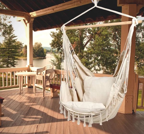 a hammock chair seen hanging outdoors on a patio