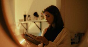 Image of a woman with dark hair reading a book
