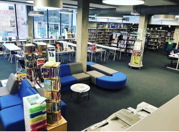 A photo of Glenthorne High School Library, showing lots of seating, book displays, and face-out books.