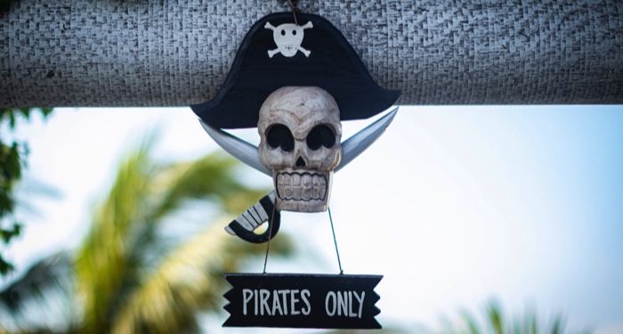 a decorative skull & crossbones with a sign hanging form it that reads:"pirates only"