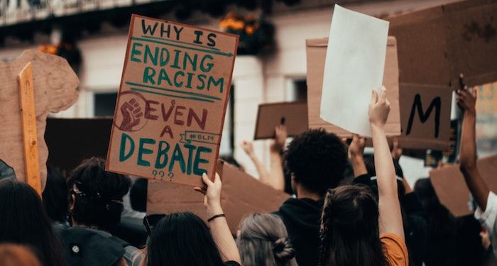 why is ending racism even a debate protest sign