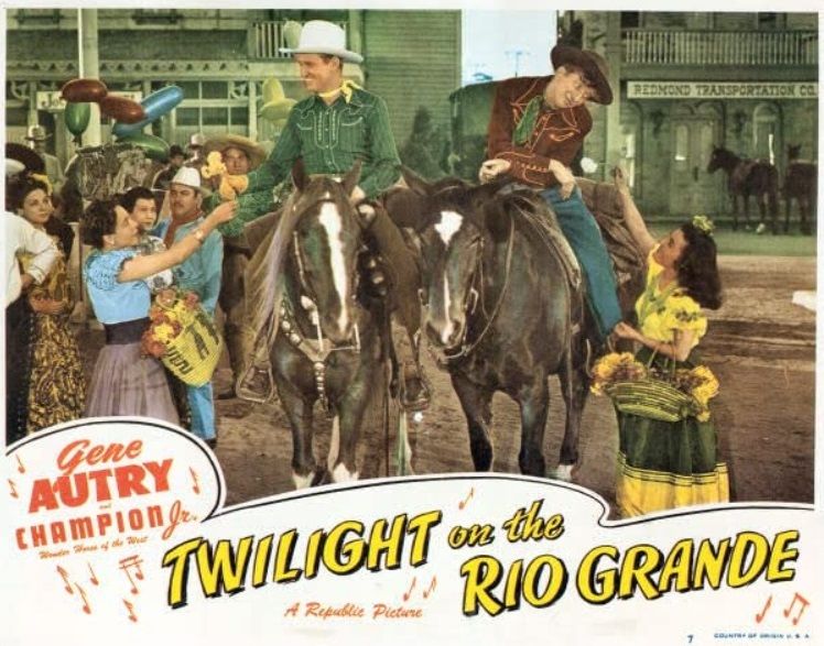 A colorized promotional image from Twilight on the Rio Grande. Gene Autry and Sterling Holloway sit on horseback as Mexican women offer then flowers.