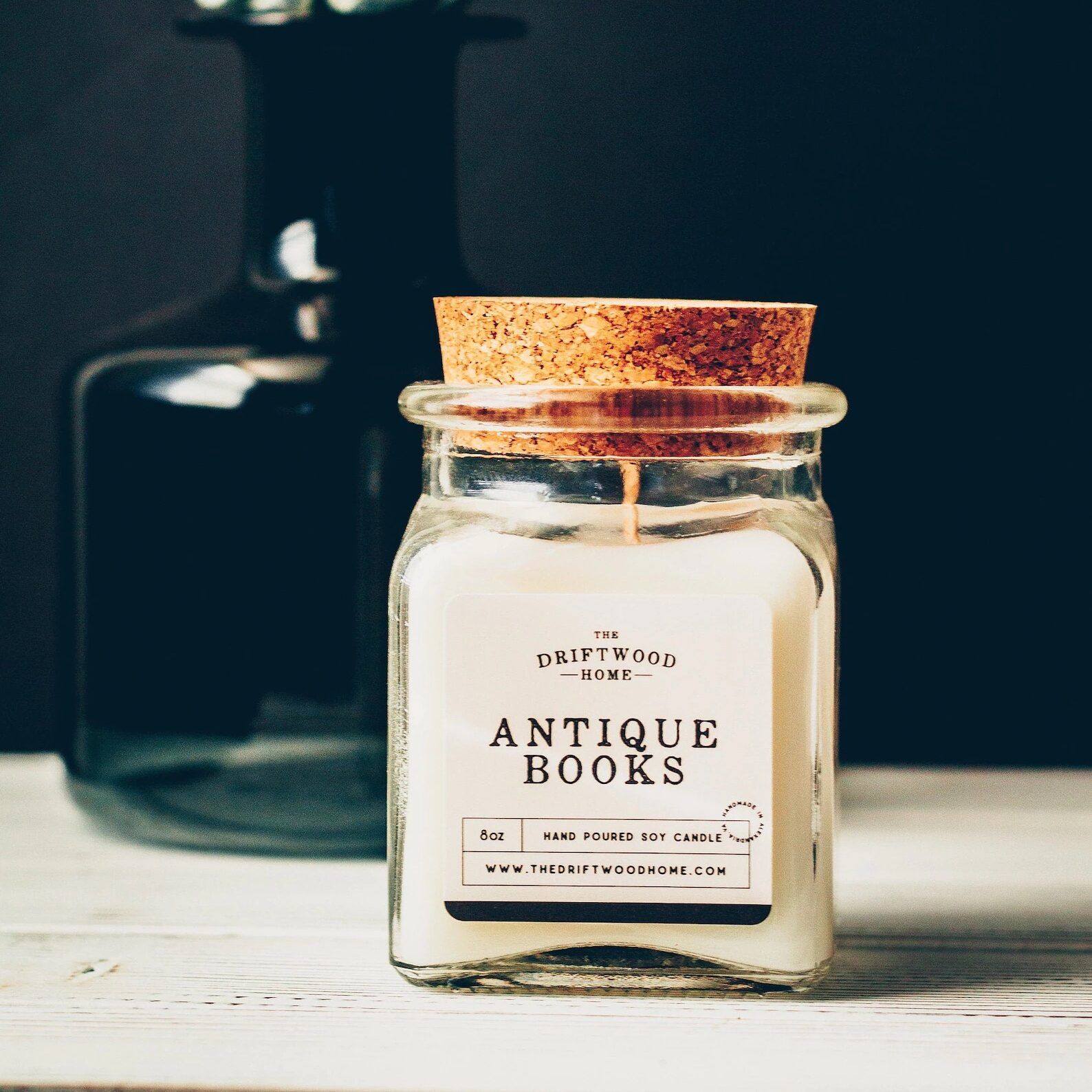Gift for book lover: White candle in glass container with a cork top