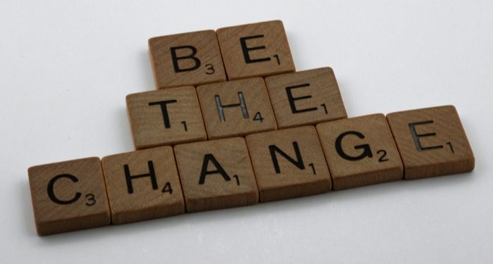 scrabble tiles arranged to spell the words "be the change"