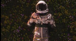 person in a space suit in a field of flowers
