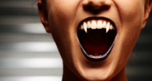 a photo of a person baring vampire fangs