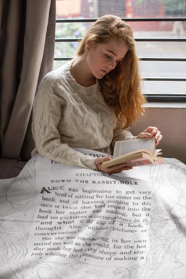 white blanket based on the book and featuring first page of Alice's Adventures in Wonderland