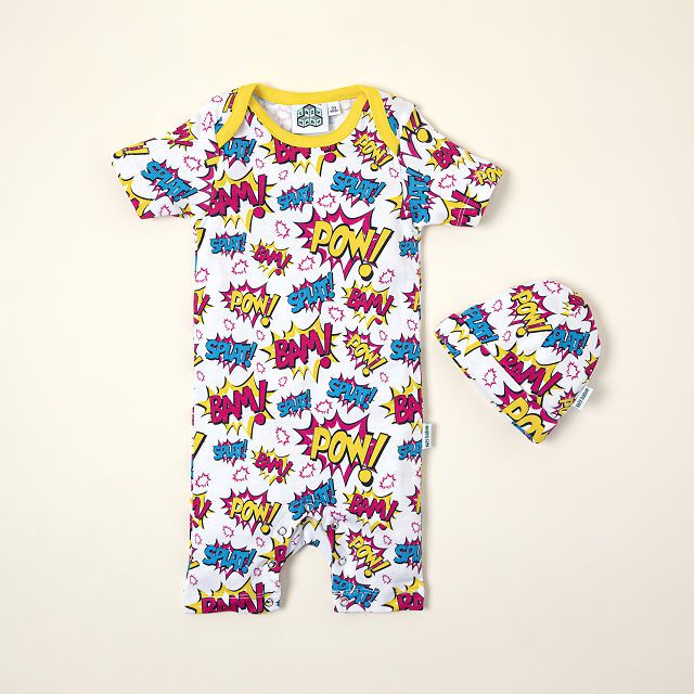 A brightly colored body suit for babies along with a hat that's covered in comic phrases like Pow! Bam! and Splat! 