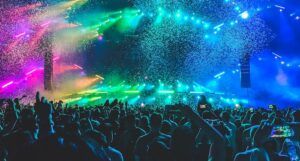 a photo of a concert with colorful lights