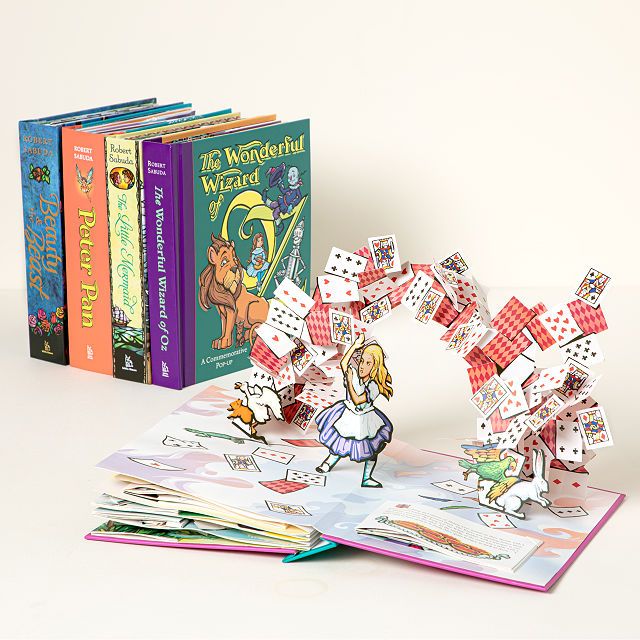 Collection of popup books featuring fairytales. The book open in the front of the image is for Alice in Wonderland. 