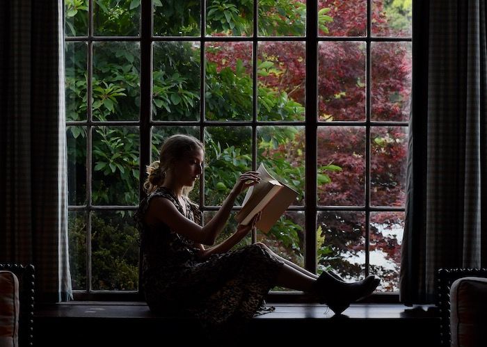 woman reading in window