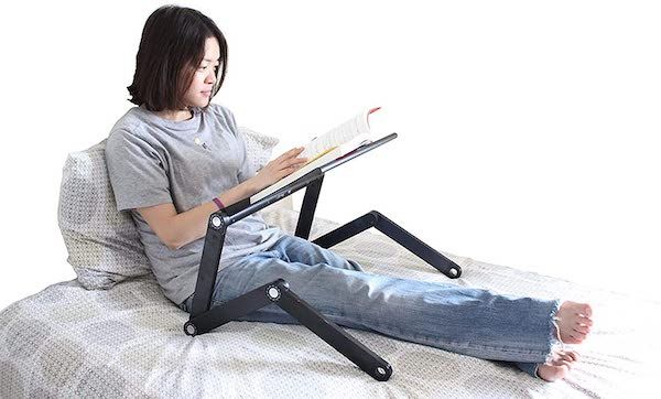 Woman sitting in bed with a height-adjustable book holder over her lap