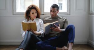 Black man and woman sitting and reading