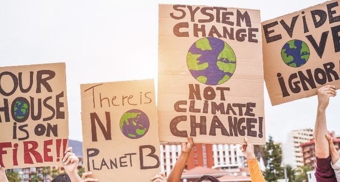 image of four hand-made climate change protest signs