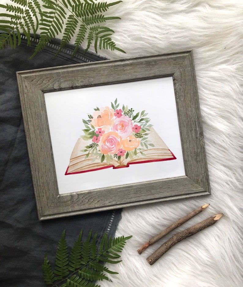 Watercolor picture of book with flowers blooming from it.