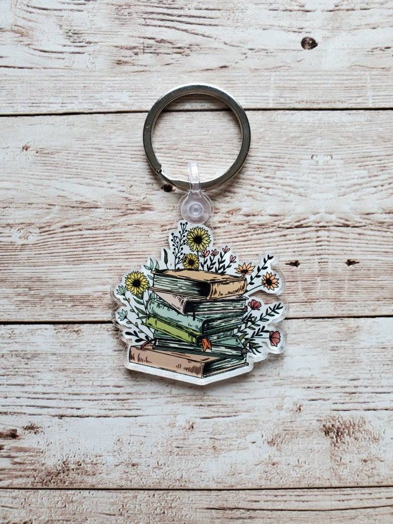 Keychain with stack of books and flowers