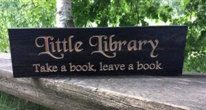 a sign reading Little Library: Take a book, leave a book