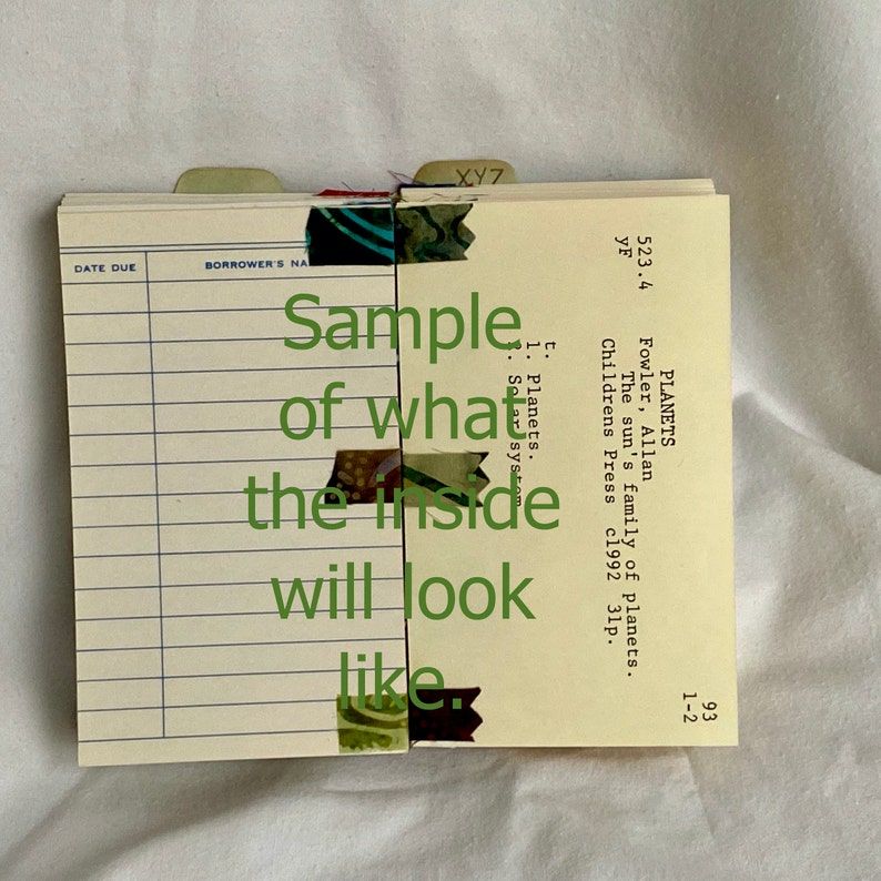 Image of the inside of a journal made from library cards. 