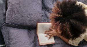 a photo of someone reading in bed