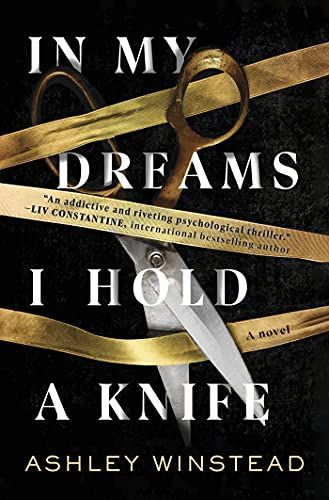 cover of In My Dreams I Hold a Knife by Ashley Winstead: the title of the book in large white text, woven between the text are three strands of gold ribbon and a large pair of scissors cutting into it