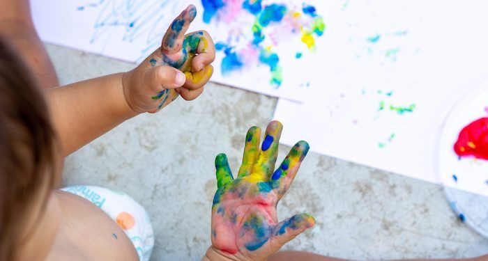 a photo of a baby's hands covered in paint