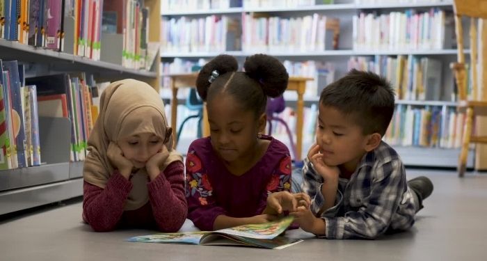 diverse children reading in a library