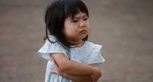 image of a young asian child who looks angry