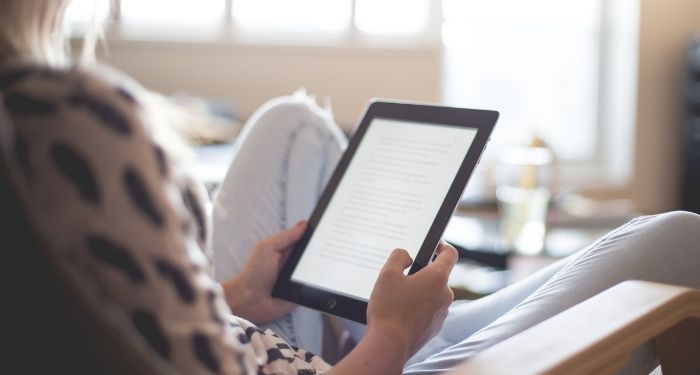 image of a person reading on an ereader