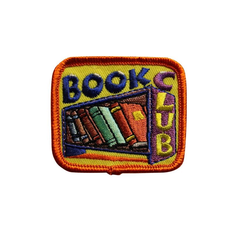 Image of an iron on patch that reads "book club" and has a colorful shelf of books. 
