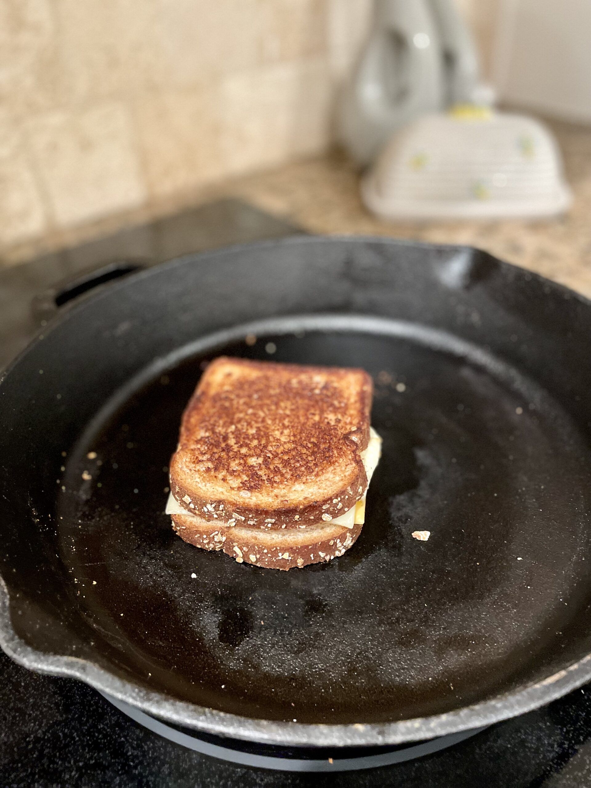 a photo of a grilled cheese in a cast iron pan, property of the author