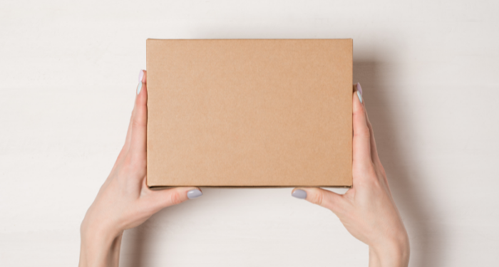 a photo of hands holding a cardboard box