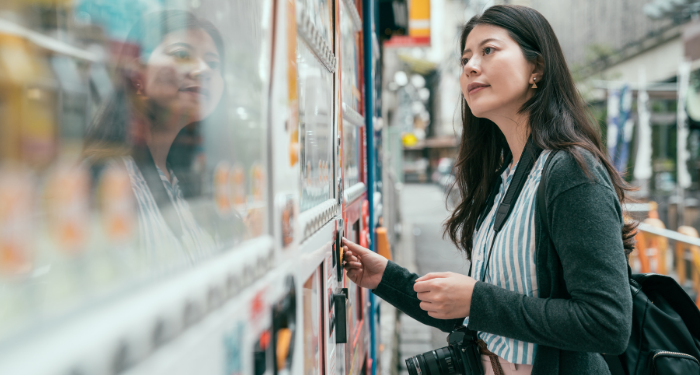 a photo of a person using a vending machine