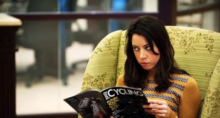April Ludgage from the show Parks and Rec reading Cycling magazine