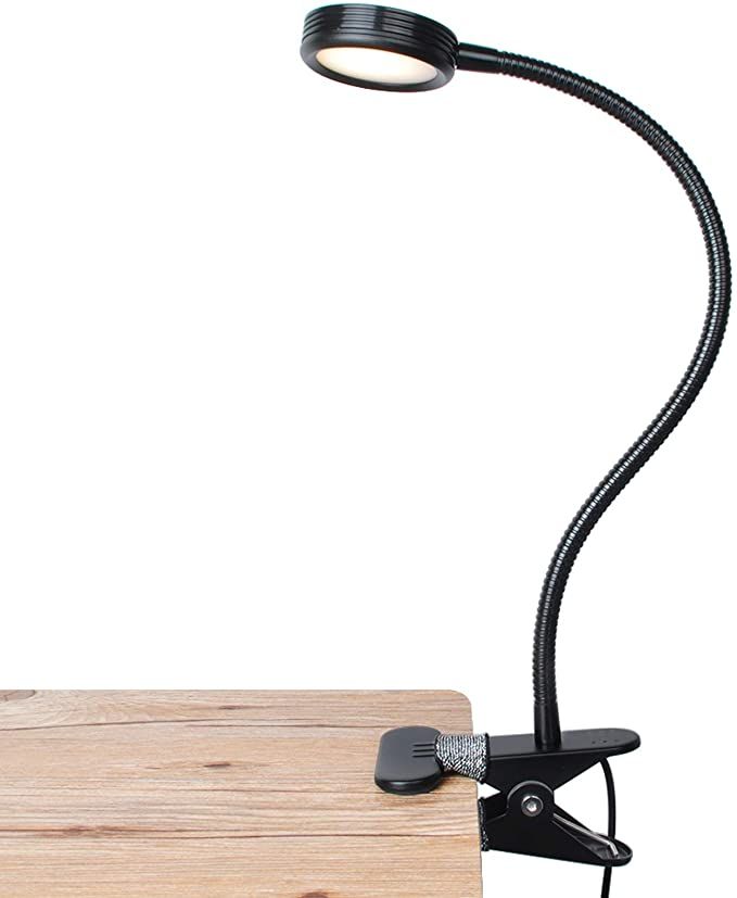 a photo of a reading lamp clamped onto a desk