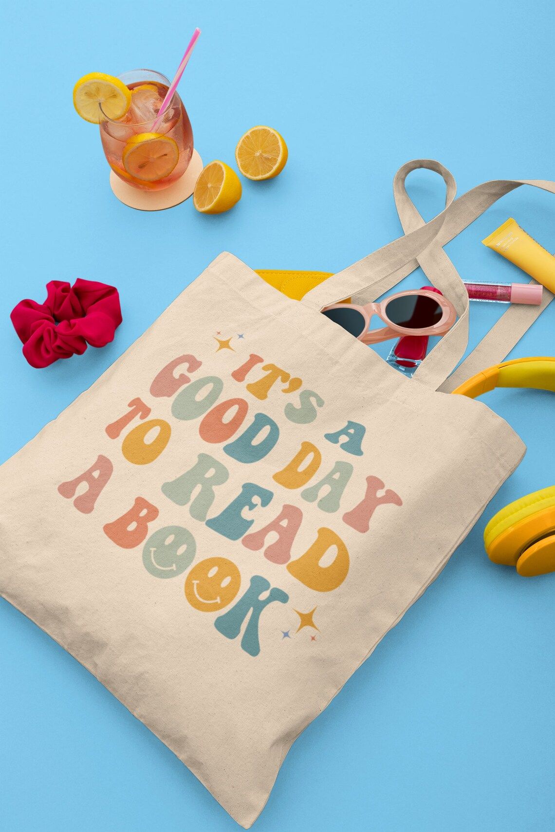 Canvas tote with groovy font reading "it's a good day to read a book."