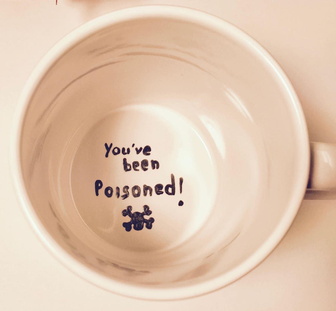 Photo of a mug that says "you've been poisoned" on the inside