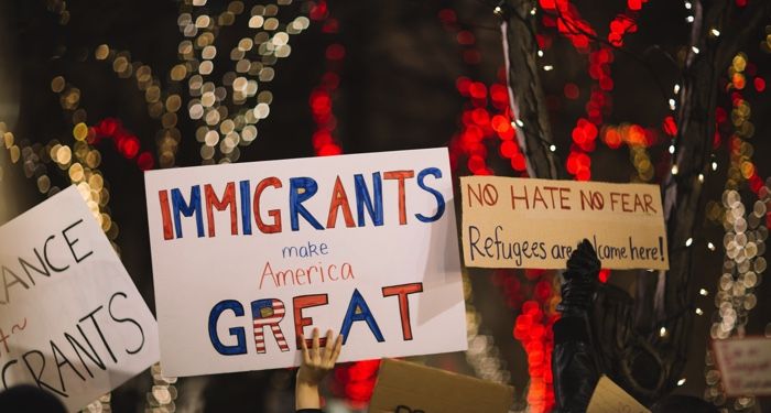 signs at a protest in support of immigration