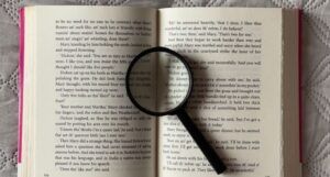 magnifying glass on top of the page of a book