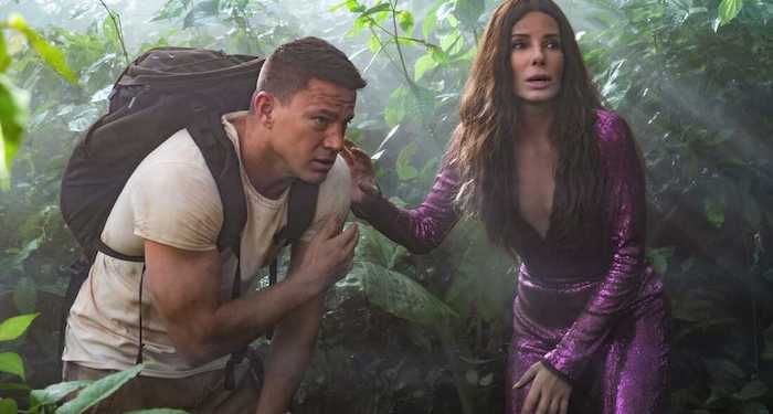 A still from The Lost City showing Sandra Bullock and Channing Tatum in the jungle