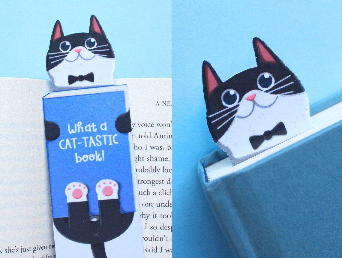 Image of a bookmark featuring a tuxedo cat. In blue, it reads "what a cat-tastic book."